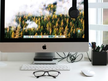 Free Stylish home office workspace featuring a computer setup with accessories. Stock Photo