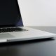 silver laptop computer on black table