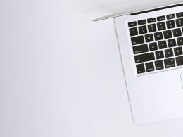 Free Aerial view of a sleek laptop keyboard on a clean, white surface, ideal for tech backgrounds. Stock Photo