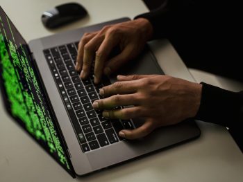crop-cyber-spy-hacking-system-while-typing-on-laptop