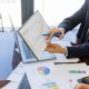 Free Business professionals discussing financial graphs and charts in an office setting. Stock Photo