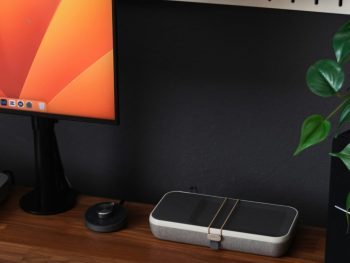 a desk with a laptop, keyboard, mouse and a monitor