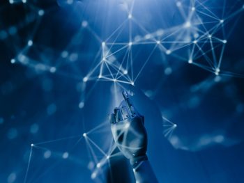 Free A robotic hand reaching into a digital network on a blue background, symbolizing AI technology. Stock Photo