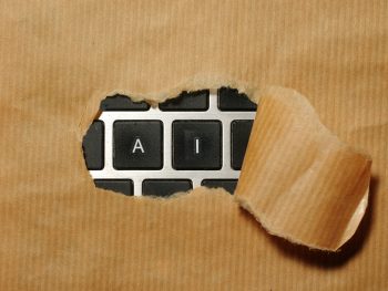 A piece of cardboard with a keyboard appearing through it