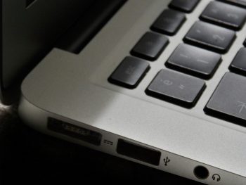 Free Detailed view of a silver laptop showing keyboard and multiple ports. Stock Photo
