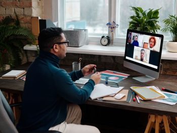 teacher-video-calling-with-his-students-using-a-computer