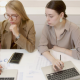 two women with laptops